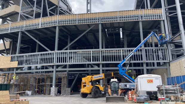 Construction equipment and a crane at a work site at Penn State's Beaver Stadium.