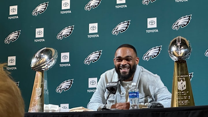 Framed by the two Lombardi Trophies he helped deliver to the Eagles, Brandon Graham smiles during his retirement press conference on March 18, 2025.