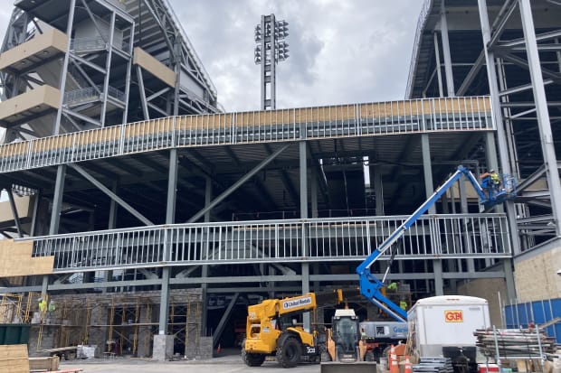 Construction equipment and a crane at a work site at Penn State's Beaver Stadium.