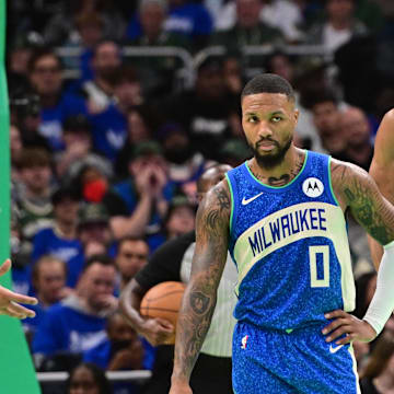 Milwaukee Bucks guard Damian Lillard (0) and forward Giannis Antetokounmpo (34) looks on during a timeout in the fourth quarter against the New York Knicks at Fiserv Forum. 