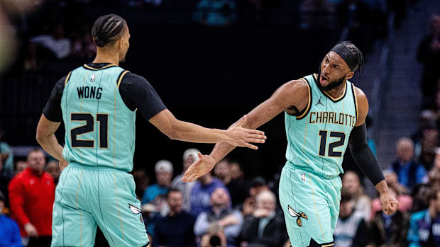 Charlotte Hornets forward Josh Okogie (12) celebrates with guard Isaiah Wong (21) during the second quarter