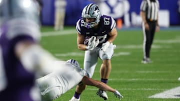 Sep 21, 2024; Provo, Utah, USA; Kansas State Wildcats tight end Brayden Loftin (87) runs after a catch and is tackled by Brigham Young Cougars safety Crew Wakley (7) during the first quarter at LaVell Edwards Stadium. Mandatory Credit: Rob Gray-Imagn Images