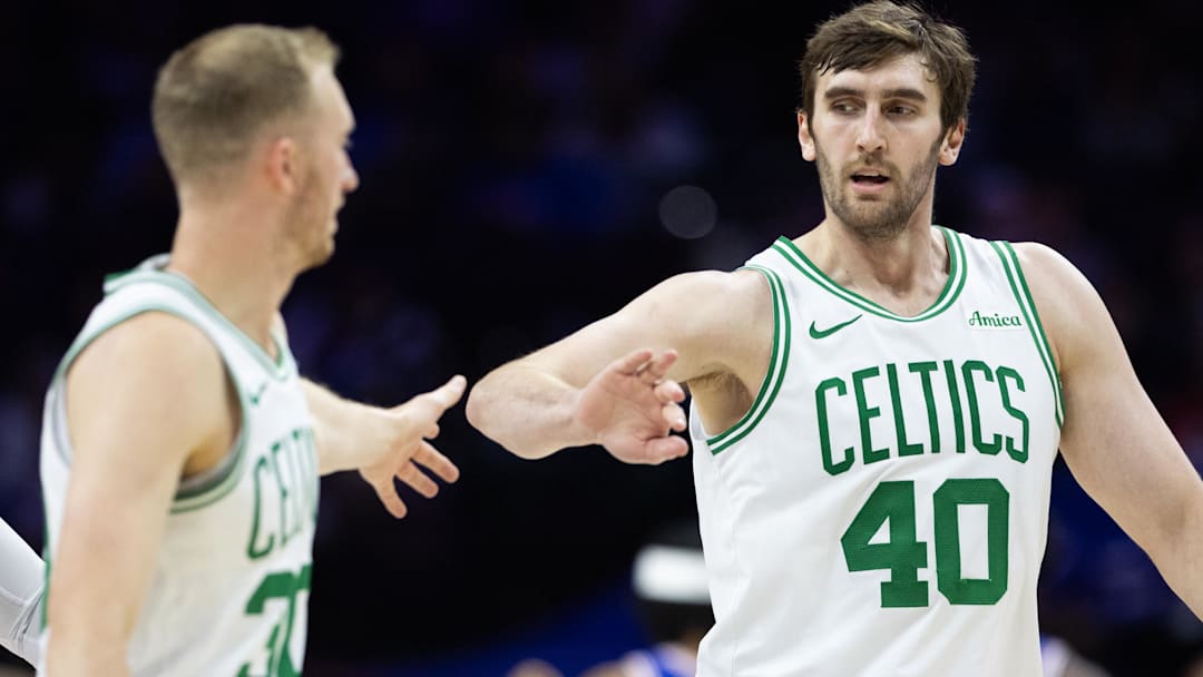Boston Celtics center Luke Kornet (40) high-fives forward Sam Hauser (30) after scoring against the Philadelphia 76ers during the third quarter at Wells Fargo Center.