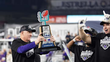 Dec 26, 2024; Phoenix, AZ, USA; Kansas State Wildcats head coach Chris Klieman celebrates with the trophy after defeating the Rutgers Scarlet Knights during the Rate Bowl at Chase Field. Mandatory Credit: Mark J. Rebilas-Imagn Images