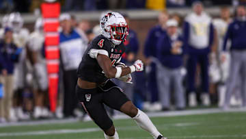 Nov 21, 2024; Atlanta, Georgia, USA; North Carolina State Wolfpack wide receiver Dacari Collins (4) runs after a catch against the Georgia Tech Yellow Jackets in the fourth quarter at Bobby Dodd Stadium at Hyundai Field. Mandatory Credit: Brett Davis-Imagn Images