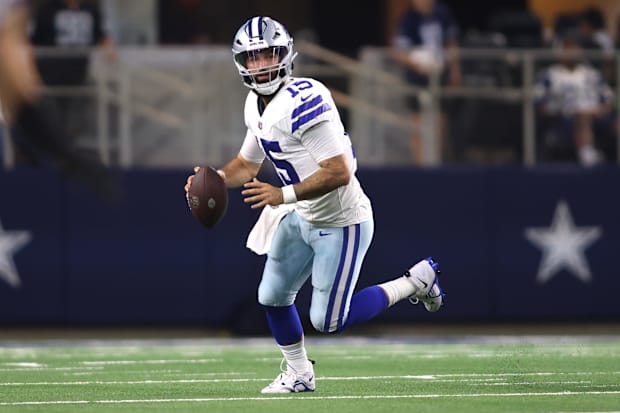 Dallas Cowboys quarterback Will Grier rolls out in the second quarter against the Las Vegas Raiders.