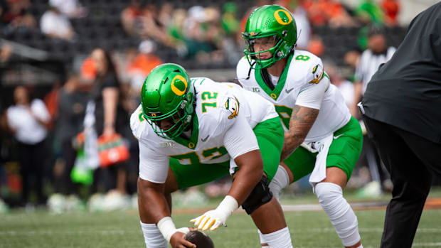 Oregon offensive lineman Iapani Laloulu snaps the ball to Oregon quarterback Dillon Gabriel during warm ups as the Oregon Sta