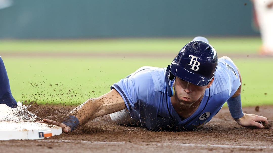 Jun 1, 2025; Houston, Texas, USA; Tampa Bay Rays center fielder Kameron Misner (26) dives back to first base against the Houston Astros in the third inning at Daikin Park. Mandatory Credit: Thomas Shea-Imagn Images