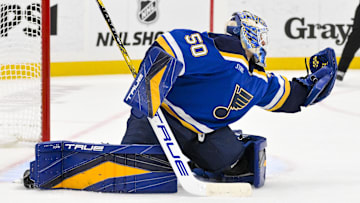 Nov 21, 2024; St. Louis, Missouri, USA;  St. Louis Blues goaltender Jordan Binnington (50) defends the net against the San Jose Sharks during the third period at Enterprise Center. Mandatory Credit: Jeff Curry-Imagn Images