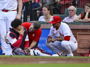 St. Louis Cardinals catcher Willson Contreras is looked at by the team's medical staff. 