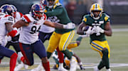 Jun 14, 2024; Edmonton, Alberta, CAN; Montreal Alouettes defensive lineman Mustafa Johnson (94) tries to run down Edmonton Elks running back Kevin Brown (4) during the second half at Commonwealth Stadium. Mandatory Credit: Perry Nelson-Imagn Images