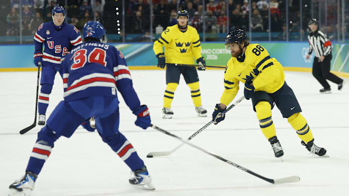 Feb 18, 2026; Milan, Italy; William Nylander (88) of Sweden in action against Auston Matthews (34) of the United States in a men's ice hockey quarterfinal during the Milano Cortina 2026 Olympic Winter Games at Milano Santagiulia Ice Hockey Arena. Mandatory Credit: Geoff Burke-Imagn Images