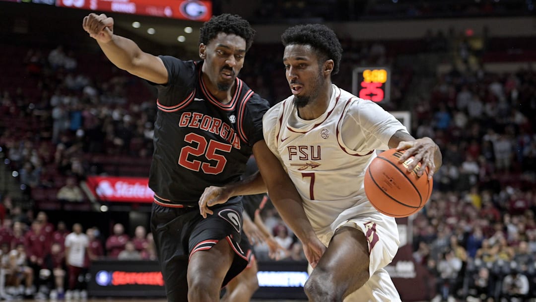 Dec 2, 2025; Tallahassee, Florida, USA; Florida State Seminoles forward Chauncey Wiggins (7) drives the ball past Georgia Bulldogs forward Justin Abson (25) during the first half at Donald L. Tucker Center. Mandatory Credit: Melina Myers-Imagn Images Dec 2, 2025; Tallahassee, Florida, USA; Florida State Seminoles forward Chauncey Wiggins (7) drives the ball past Georgia Bulldogs forward Justin Abson (25) during the first half at Donald L. Tucker Center. Mandatory Credit: Melina Myers-Imagn Images