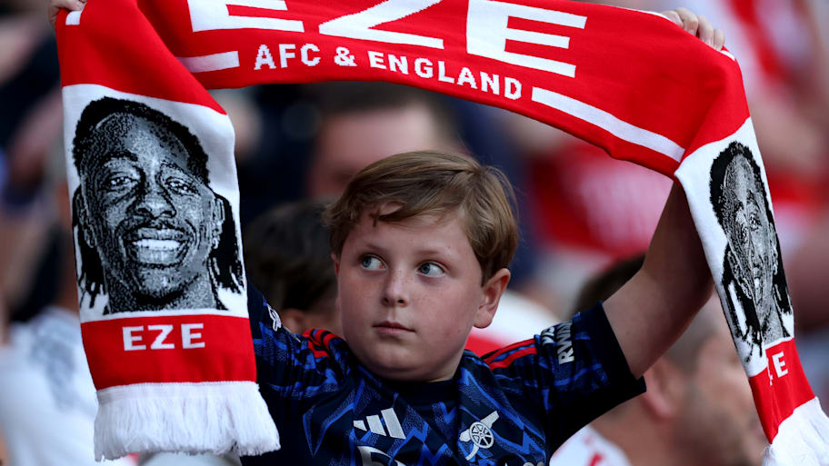 A young fan with an Eberechi Eze Arsenal scarf.