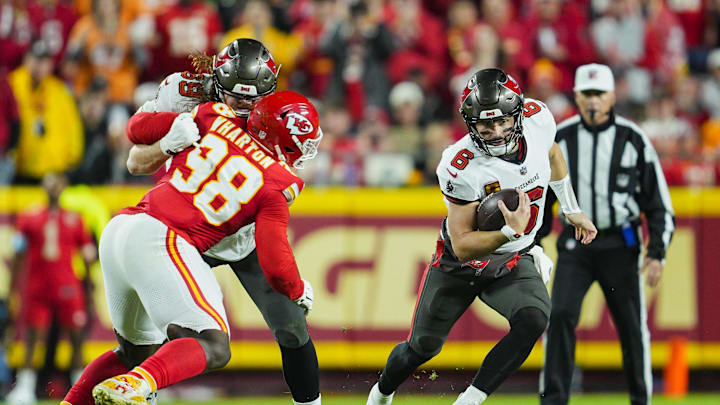 Nov 4, 2024; Kansas City, Missouri, USA; Tampa Bay Buccaneers quarterback Baker Mayfield (6) runs the ball against Kansas City Chiefs defensive tackle Tershawn Wharton (98) during the first half at GEHA Field at Arrowhead Stadium. Mandatory Credit: Jay Biggerstaff-Imagn Images