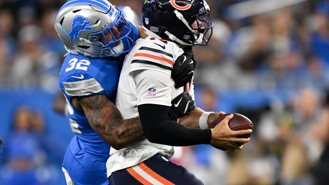 Sep 14, 2025; Detroit, Michigan, USA; Detroit Lions safety Brian Branch (32) sacks Chicago Bears quarterback Caleb Williams (18) during the fourth quarter of the game at Ford Field. Mandatory Credit: Lon Horwedel-Imagn Images