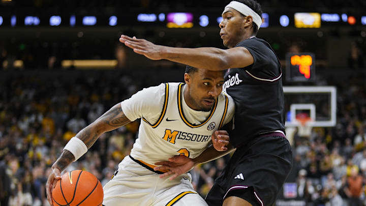 Feb 8, 2025; Columbia, Missouri, USA; Missouri Tigers guard Tamar Bates (2) drives against Texas A&M Aggies guard Zhuric Phelps (1) during the first half at Mizzou Arena. Mandatory Credit: Jay Biggerstaff-Imagn Images