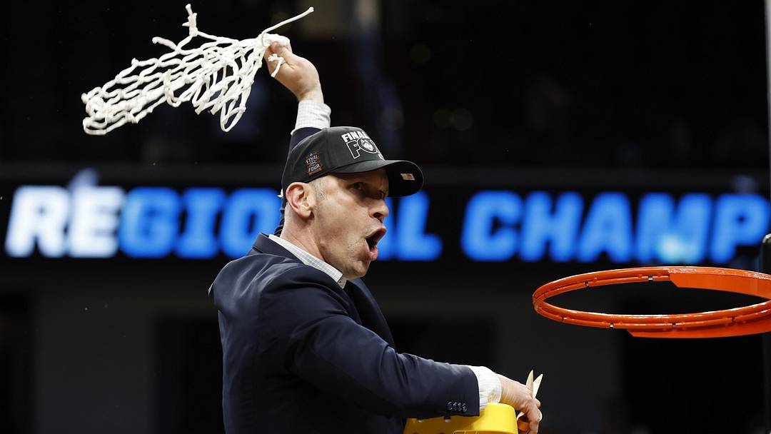 UConn Huskies head coach Dan Hurley cuts down the net after defeating the Duke Blue Devils in an Elite Eight game of the East Regional of the men's 2026 NCAA Tournament at Capital One Arena. 