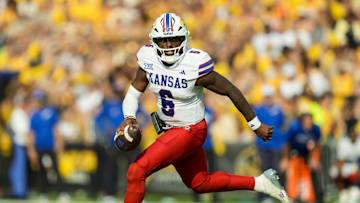 Sep 6, 2025; Columbia, Missouri, USA; Kansas Jayhawks quarterback Jalon Daniels (6) rolls out to pass during the second half against the Missouri Tigers at Faurot Field at Memorial Stadium. Mandatory Credit: Jay Biggerstaff-Imagn Images