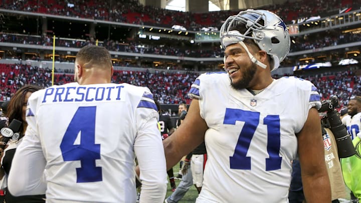 Dallas Cowboys quarterback Dak Prescott and offensive tackle La'el Collins celebrate after a game against the Atlanta Falcons 