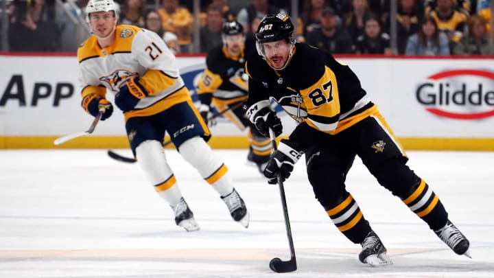 Apr 15, 2024; Pittsburgh, Pennsylvania, USA;  Pittsburgh Penguins center Sidney Crosby (87) skates with the puck against the Nashville Predators during the first period at PPG Paints Arena. Mandatory Credit: Charles LeClaire-USA TODAY Sports