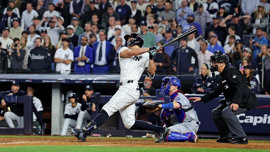 Oct 30, 2024; New York, New York, USA; New York Yankees designated hitter Giancarlo Stanton (27) hits an RBI sacrifice fly during the sixth inning against the Los Angeles Dodgers in game four of the 2024 MLB World Series at Yankee Stadium. Oct 30, 2024; New York, New York, USA; New York Yankees designated hitter Giancarlo Stanton (27) hits an RBI sacrifice fly during the sixth inning against the Los Angeles Dodgers in game four of the 2024 MLB World Series at Yankee Stadium.