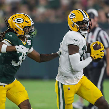 Green Bay Packers wide receiver Malik Heath catches a pass against Gregory Junior on Family Night.