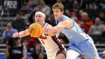 Mar 21, 2025; Milwaukee, WI, USA; Mississippi Rebels guard Sean Pedulla (3) and North Carolina Tar Heels guard Cade Tyson (5) chase a loose ball during the first half of a first round NCAA men’s tournament game at Fiserv Forum. Mandatory Credit: Jeff Hanisch-Imagn Images