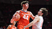 Nov 24, 2025; Champaign, Illinois, USA; Illinois Fighting Illini forward Zvonimir Ivisic (44) grabs a rebound in front of UT Rio Grande Valley Vaqueros guard Julien Gomez (13) during the second half at State Farm Center. Mandatory Credit: Ron Johnson-Imagn Images