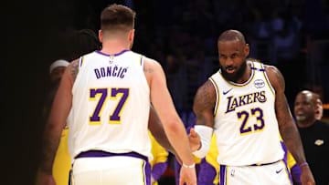 Mar 2, 2025; Los Angeles, California, USA; Los Angeles Lakers forward LeBron James (23) and guard Luka Doncic (77) react after a play during the first quarter against the LA Clippers at Crypto.com Arena. Mandatory Credit: Jason Parkhurst-Imagn Images