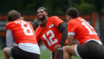 Browns quarterbacks Shedeur Sanders (12), Kenny Pickett (8) and Joe Flacco (15) talk during minicamp June 10, 2025, in Berea.