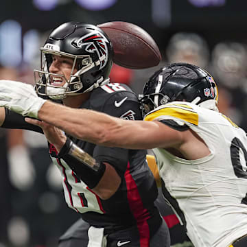 Sep 8, 2024; Atlanta, Georgia, USA; Pittsburgh Steelers linebacker T.J. Watt (90) strips the ball from Atlanta Falcons quarterback Kirk Cousins (18) at Mercedes-Benz Stadium. Mandatory Credit: Dale Zanine-Imagn Images