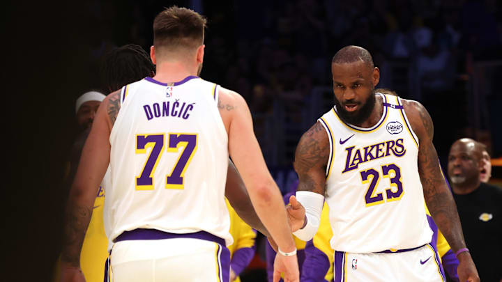 Mar 2, 2025; Los Angeles, California, USA; Los Angeles Lakers forward LeBron James (23) and guard Luka Doncic (77) react after a play during the first quarter against the LA Clippers at Crypto.com Arena. Mandatory Credit: Jason Parkhurst-Imagn Images