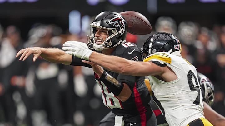 Sep 8, 2024; Atlanta, Georgia, USA; Pittsburgh Steelers linebacker T.J. Watt (90) strips the ball from Atlanta Falcons quarterback Kirk Cousins (18) at Mercedes-Benz Stadium. Mandatory Credit: Dale Zanine-Imagn Images