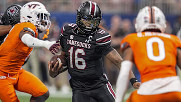 Aug 31, 2025; Atlanta, Georgia, USA; South Carolina Gamecocks quarterback LaNorris Sellers (16) runs against Virginia Tech Hokies safety Quentin Reddish (0) during the first half at Mercedes-Benz Stadium. Mandatory Credit: Dale Zanine-Imagn Images