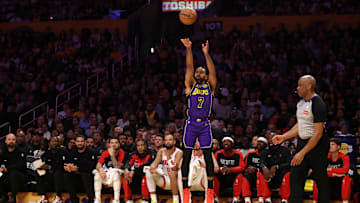 Mar 31, 2025; Los Angeles, California, USA;  Los Angeles Lakers guard Gabe Vincent (7) shoots three point basket during the first half against the Houston Rockets at Crypto.com Arena. Mandatory Credit: Kiyoshi Mio-Imagn Images