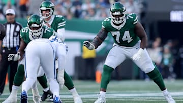 Nov 17, 2024; East Rutherford, New Jersey, USA; New York Jets offensive tackle Olu Fashanu (74) blocks for quarterback Aaron Rodgers (8) during the second quarter against the Indianapolis Colts at MetLife Stadium. 