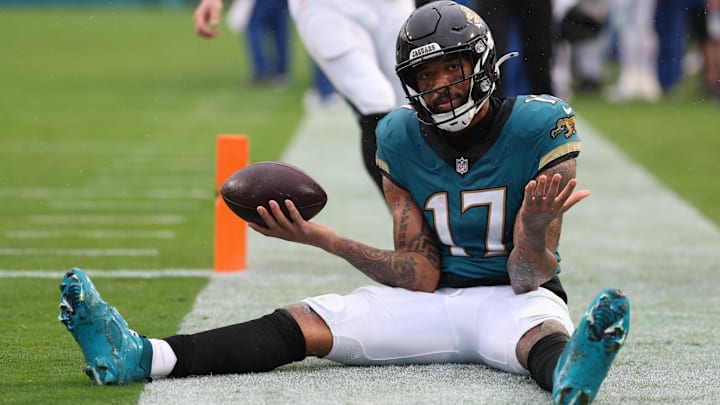 Dec 7, 2025; Jacksonville, Florida, USA;  Jacksonville Jaguars wide receiver Tim Patrick (17) sits on the field after catching a touchdown pass against the Indianapolis Colts during the first half at EverBank Stadium.