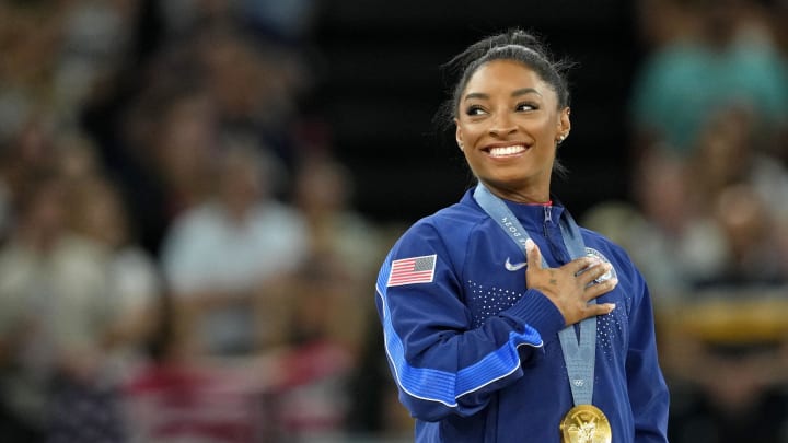 Simone Biles of the United States during the national anthem with her gold medal from the 2024 Paris Olympic Games. 