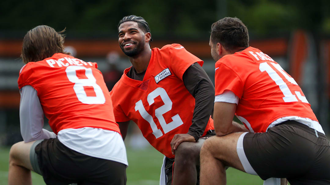 Browns quarterbacks Shedeur Sanders (12), Kenny Pickett (8) and Joe Flacco (15) talk during minicamp June 10, 2025, in Berea.
