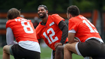Browns quarterbacks Shedeur Sanders (12), Kenny Pickett (8) and Joe Flacco (15) talk during minicamp June 10, 2025, in Berea.