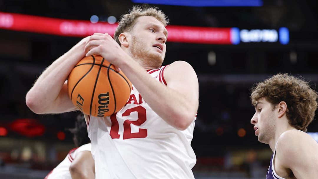 Mar 11, 2026; Chicago, IL, USA; Indiana Hoosiers forward Tucker Devries (12) grabs a rebound against the Northwestern Wildcats during the first half at United Center.