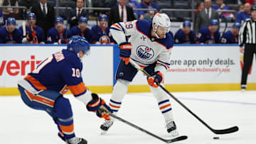 Mar 14, 2025; Elmont, New York, USA; Edmonton Oilers center Leon Draisaitl (29) skates with the puck while New York Islanders right wing Simon Holmstrom (10) defends during the third period at UBS Arena. Mandatory Credit: Thomas Salus-Imagn Images