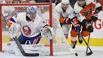 Jan 30, 2025; Philadelphia, Pennsylvania, USA; Philadelphia Flyers right wing Tyson Foerster (71) and New York Islanders defenseman Adam Pelech (3) battle for the puck with goaltender Ilya Sorokin (30 during the second period at Wells Fargo Center. Mandatory Credit: Eric Hartline-Imagn Images