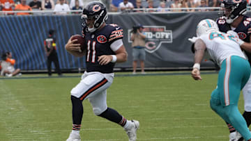 Case Keenum tiptoes away to elude the rush in Sunday's preseason opener.