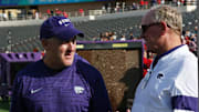 Oct 23, 2021; Lubbock, Texas, USA;  Kansas State Wildcats Chris Klieman visits with Kansas State Director of Athletics Gene Taylor before the game against the Texas Tech Red Raiders at Jones AT&T Stadium. Mandatory Credit: Michael C. Johnson-Imagn Images