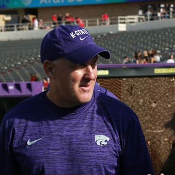 Oct 23, 2021; Lubbock, Texas, USA;  Kansas State Wildcats Chris Klieman visits with Kansas State Director of Athletics Gene Taylor before the game against the Texas Tech Red Raiders at Jones AT&T Stadium. Mandatory Credit: Michael C. Johnson-Imagn Images