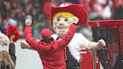 Dec 28, 2024; Bronx, NY, USA; The Nebraska Cornhuskers mascot celebrates with a fan after a play during the first half against the Boston College Eagles at Yankee Stadium.