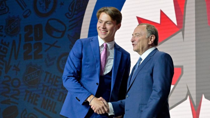 Jul 7, 2022; Montreal, Quebec, CANADA; Rutger Mcgroarty shakes hands with NHL commissioner Gary Bettman after being selected as the number fourteen overall pick to the Winnepeg Jets in the first round of the 2022 NHL Draft at Bell Centre. Mandatory Credit: Eric Bolte-USA TODAY Sports