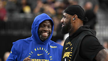 Oct 15, 2024; Las Vegas, Nevada, USA; Golden State Warriors forward Draymond Green (23) and Los Angeles Lakers forward LeBron James (23) talk on court before warm up at T-Mobile Arena. Mandatory Credit: Candice Ward-Imagn Images